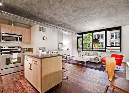 a living room with a kitchen and an open floor plan