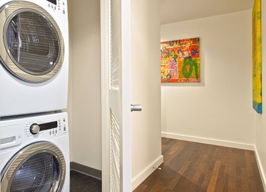 a washer and dryer in a laundry room next to a door