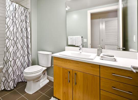 a bathroom with a toilet sink and shower