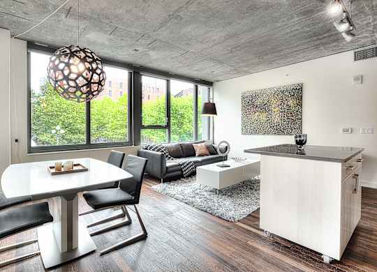 a living room with a large window and a table and chairs