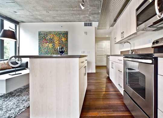 a kitchen with white cabinets and stainless steel appliances