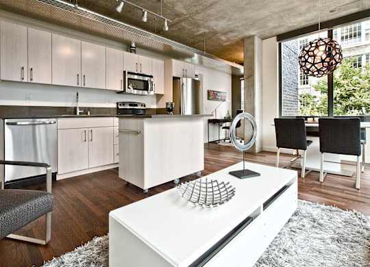 a living room with a kitchen and a dining room