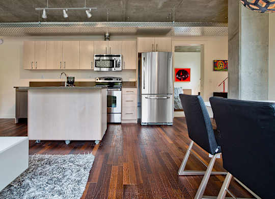 a kitchen with white cabinets and a stainless steel refrigerator