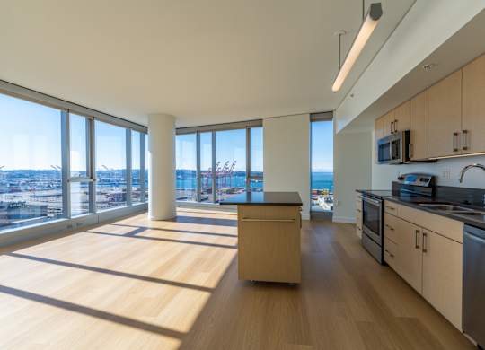 an open kitchen and living room with a view of the city