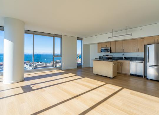 an open kitchen and living room with a view of the ocean