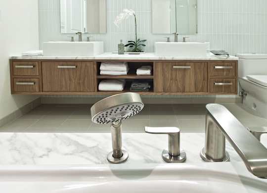 a bathroom with a shower and a sink and a toilet
