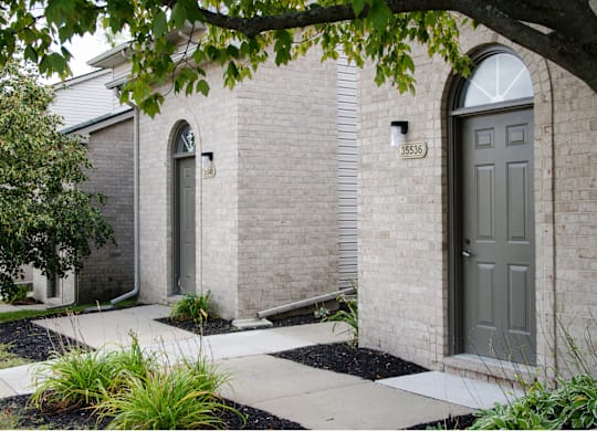 House with grey door at Woodland Meadows, Clinton Township, 48035