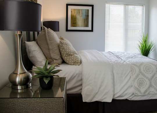 Bedroom with Nightstand at Pine Ridge Apartments, Rochester Hills, MI, 48307