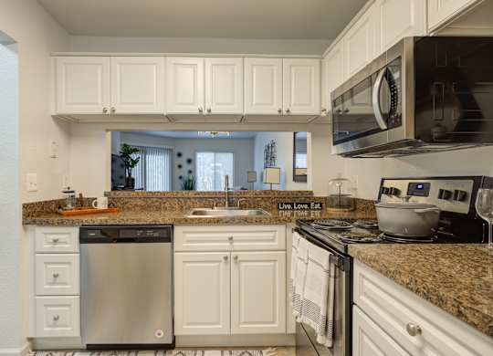 Kitchen with White Cabinets at Hidden Lakes Apartments, Clarkston, MI, 48346