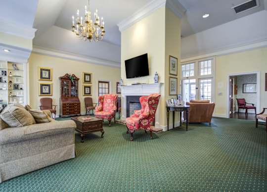 A living room with a fireplace and a television at Highlands at Warwick Apartments, Lilitz, PA 17543