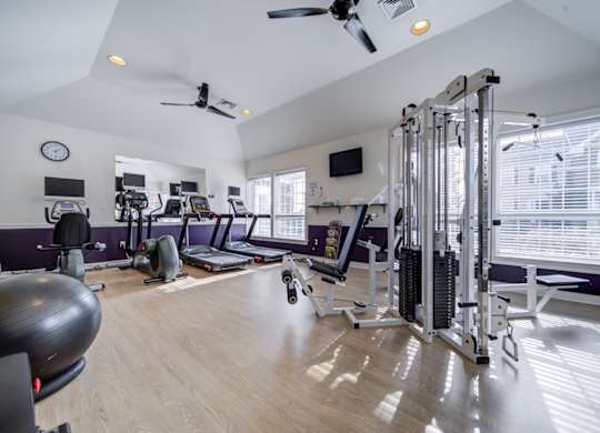 A spacious home gym with a variety of exercise equipment at Highlands at Warwick Apartments, Lilitz, 17543