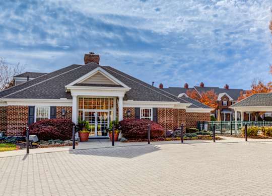 A brick house with a large front yard at Highlands at Warwick Apartments, Lilitz