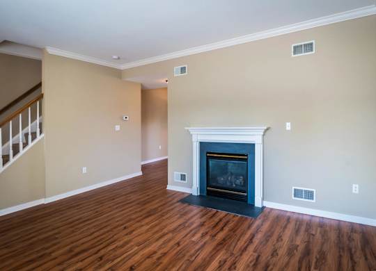 A living room with a fireplace and wood flooring at Highlands at Warwick Apartments, Lilitz, 17543