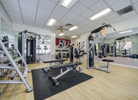 A gym with a variety of equipment including a leg press machine at The Crest at Elm Tree, Pennsylvania