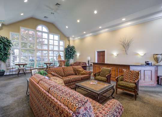 A living room with a sofa, armchairs, and a coffee table at The Crest at Elm Tree, Mount Joy Pennsylvania
