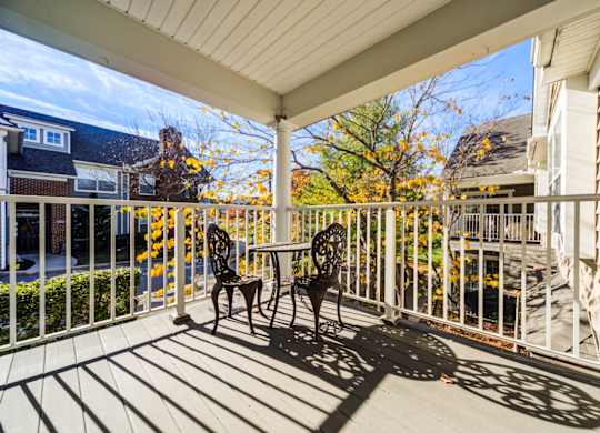 A patio with a table and chairs is covered by a roof at The Crest at Elm Tree, Pennsylvania 17552