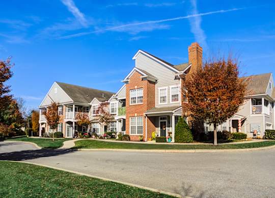 A large house with a grey roof and a red brick chimney at The Crest at Elm Tree, Mount Joy, PA