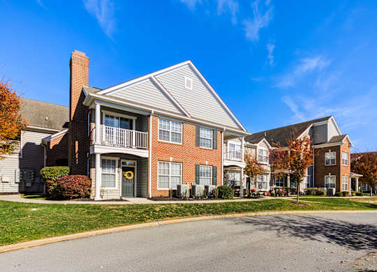 A row of townhouses with a clear blue sky above them at The Crest at Elm Tree, Mount Joy