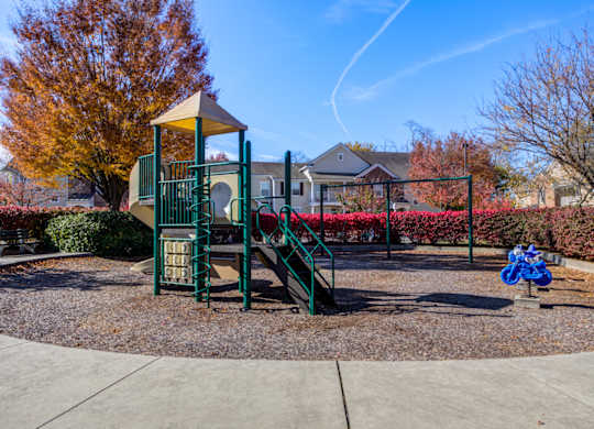 A playground with a green slide and a yellow canopy at The Crest at Elm Tree, Mount Joy Pennsylvania