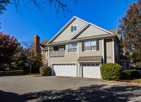 A two-story house with a garage and a driveway at The Crest at Elm Tree, Pennsylvania