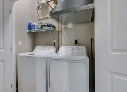 In unit washer and dryer with storage shelves at Reserve at Romeoville, Romeoville, IL