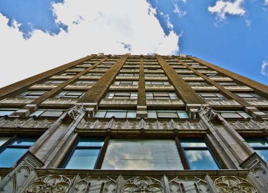 an upward view of a tall building with a cloudy sky at Garment Lofts, California, 90014