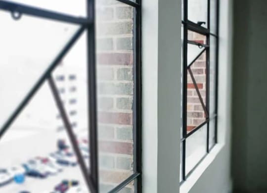 a window with a reflection of a brick wall at Garment Lofts, California