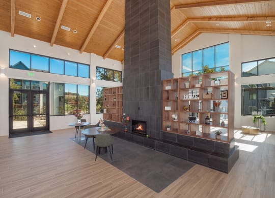 a large living room with a fireplace and a book shelf