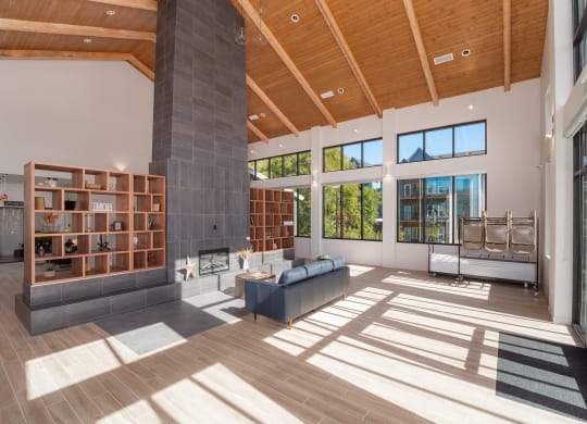a large living room with wood floors and a large fireplace