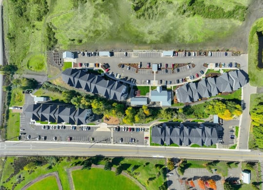a birds eye view of a parking lot with cars and buildings