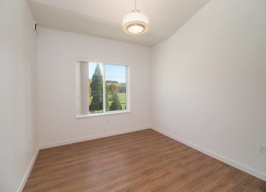 a living room with wood floors and a window