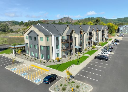 an aerial view of an apartment complex with a parking lot