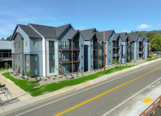 modern apartment buildings on the side of a street