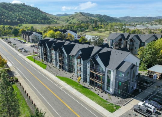 an aerial view of a row of houses with mountains in the background
