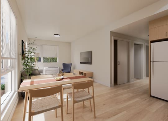 A modern kitchen with a dining table and chairs.