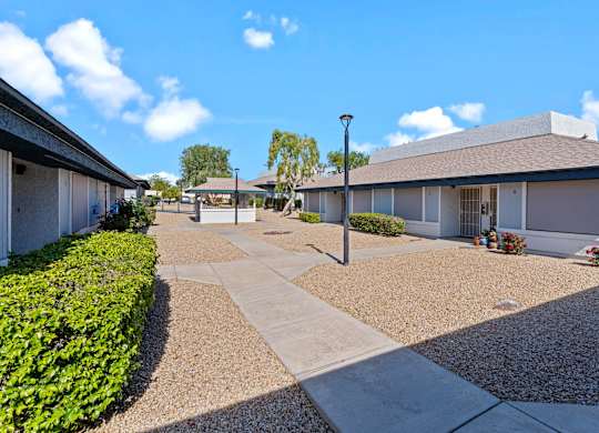A sunny day at a residential area with houses and a clear blue sky.