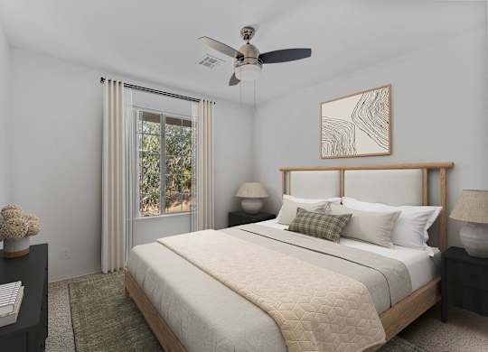A bedroom with a large bed, a ceiling fan, and a window with curtains.