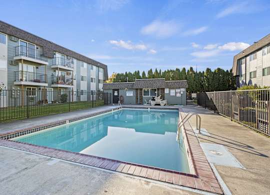 a swimming pool in front of an apartment building