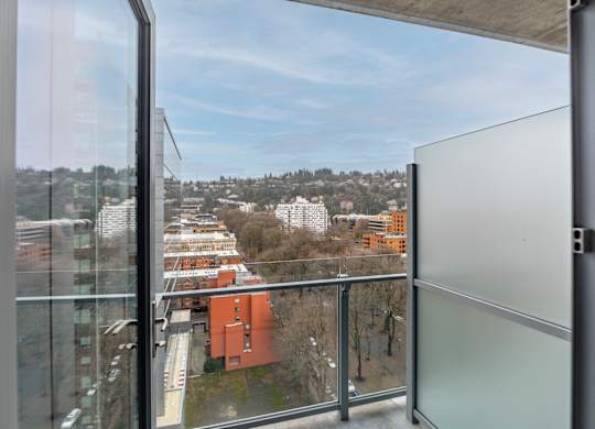 A view from a window looking out at a cityscape.