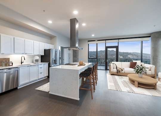 A modern kitchen with a large island and a view of the city.