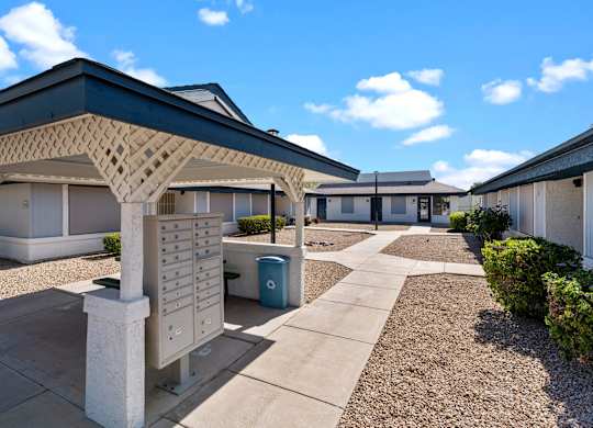 A sunny day at a residential complex with a clear blue sky.