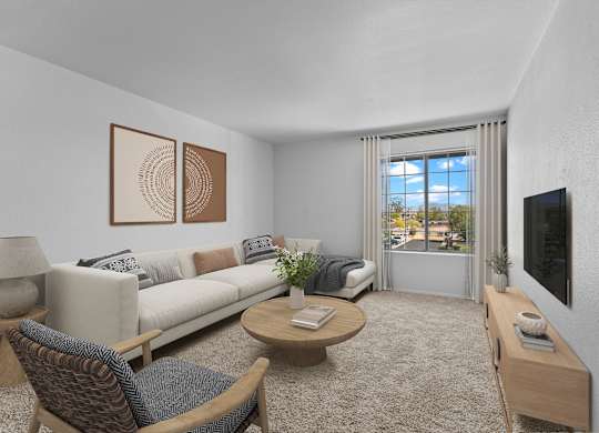 A living room with a couch, chairs, and a coffee table.