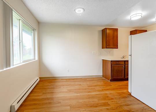 A room with wooden floors and white walls.