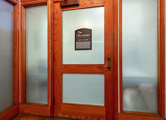 A door with a sign that says "The Olympic".