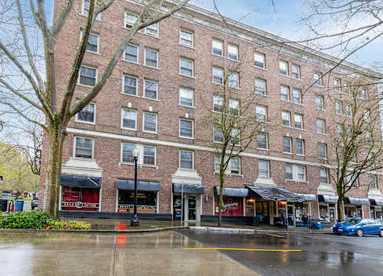 A large brick building with a red awning in front.