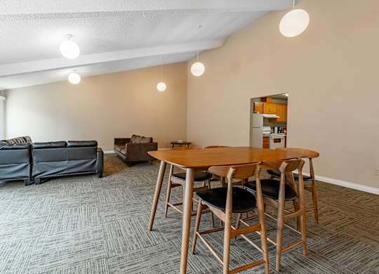 A room with a table and chairs and a couch.