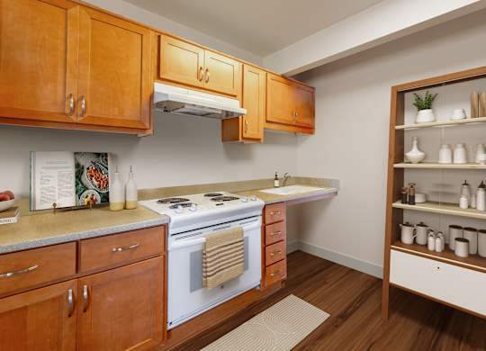 A kitchen with wooden cabinets and a white stove top oven.