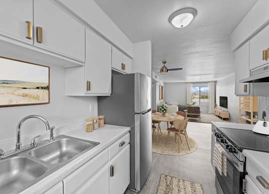 A kitchen with a stainless steel sink and refrigerator.