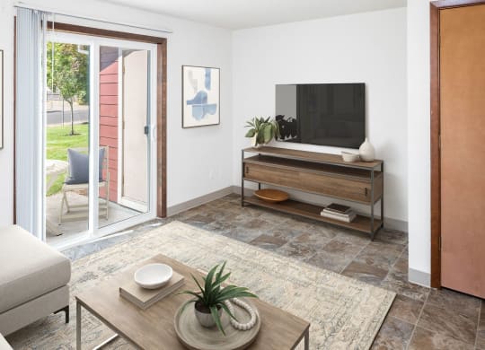 a living room with white walls and a sliding glass door
