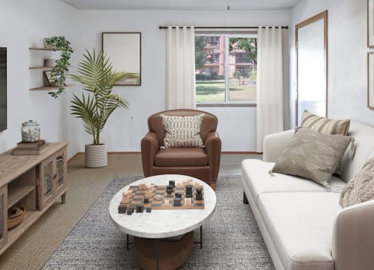 a living room with a couch chair and coffee table with a chess board on top of it